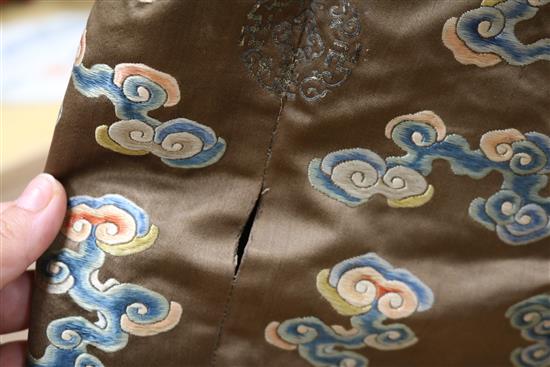 A Chinese black ground polychrome silk embroidered robe (a.f.)